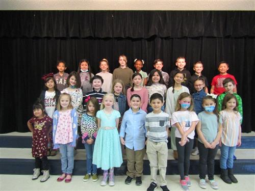 group of elementary students on stage stairs