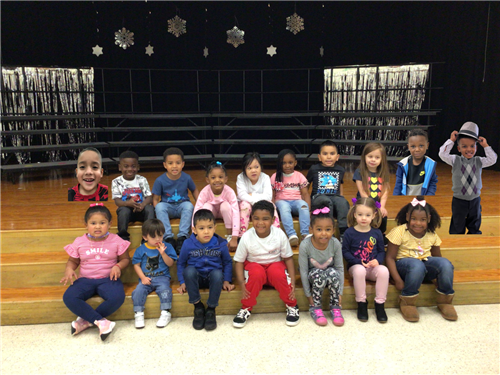 group of elementary students on stage stairs